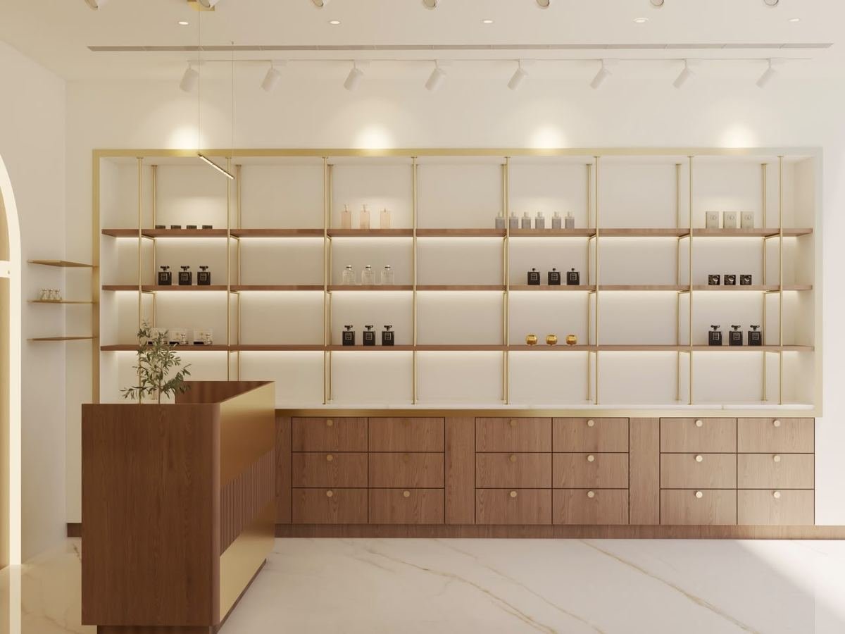 Boutique retail shelving in brass and walnut displaying perfume bottles